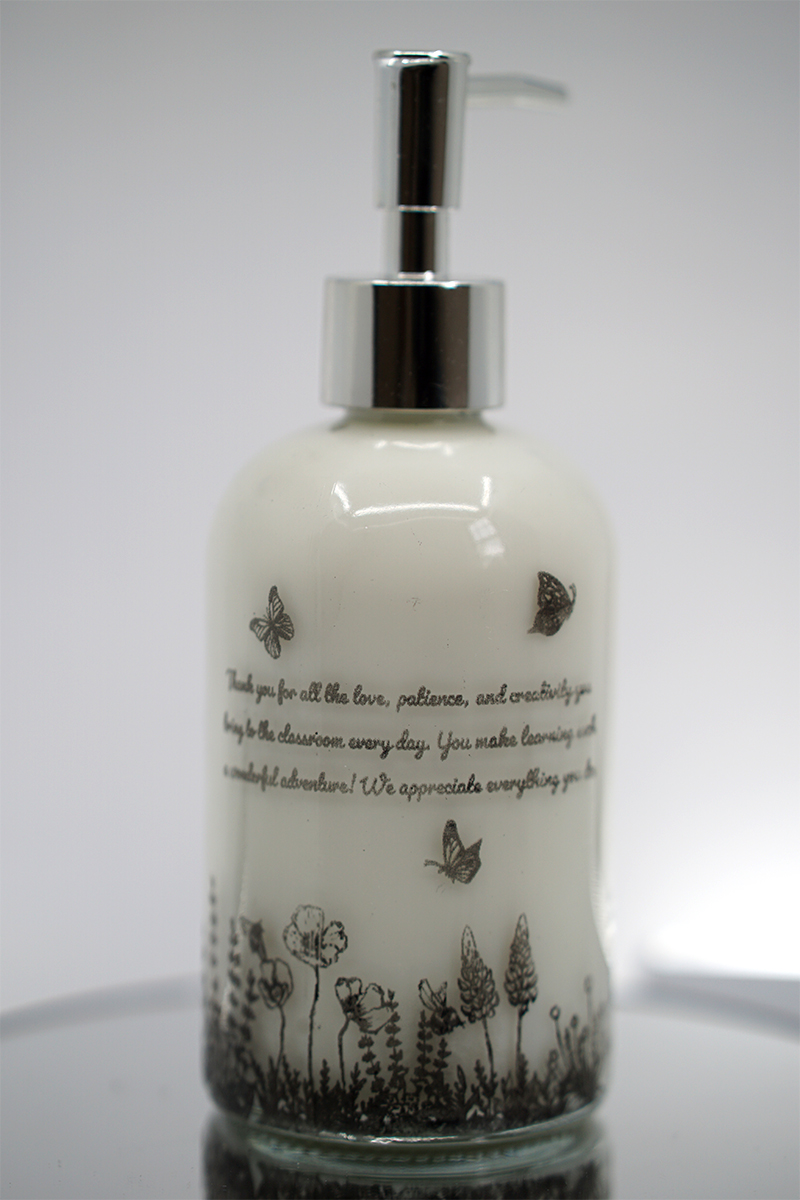 ORY Botanical Garden Glass Lotion Bottle – Personalized Message Edition ORY Botanical Garden glass lotion bottle with personalized message, ivory glass finish, delicate wildflower illustrations, and polished silver pump.