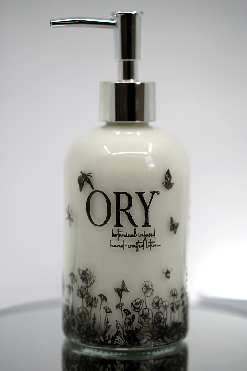 ORY Botanical Garden Glass Lotion Bottle ORY Botanical Garden glass lotion bottle with soft ivory glass, delicate wildflower illustrations, and polished silver pump for personalized skincare.