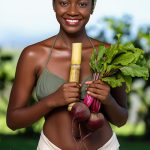 Woman holding fresh botanicals and roots, representing sodium PCA’s natural moisture-binding properties and its role in maintaining skin hydration and balance.