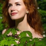 Woman with smooth, hydrated skin framed by green foliage, representing urea’s moisture-binding and skin-softening benefits in advanced skincare formulations.