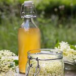 Elderflower infused oil in a glass jar and bottle, used in ORY Skincare for brightening, soothing, and anti-inflammatory skincare formulations.